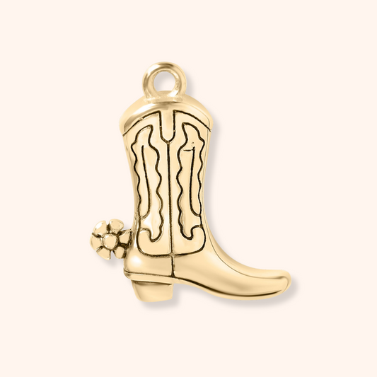 Gold cowboy boot charm on a white background