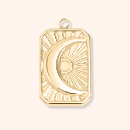 Gold pendant with a moon design on a white background