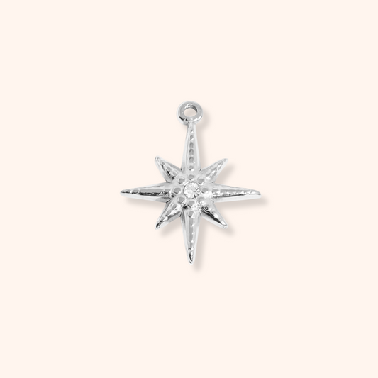 Silver star-shaped pendant on a white background
