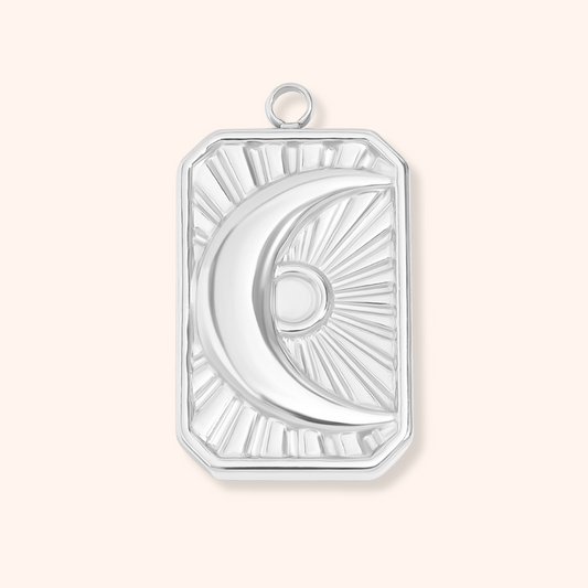 Silver pendant with a half-circle design on a white background