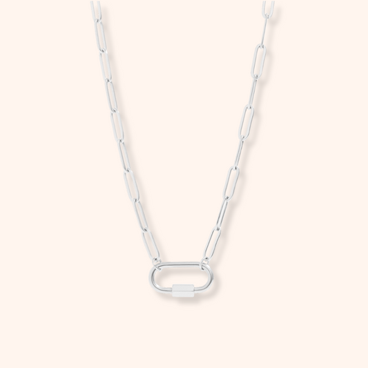 Silver chain necklace on a light pink background