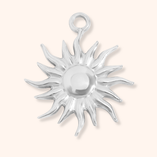 Silver sun-shaped pendant on a white background