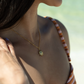 Woman wearing a striped top with a blurred natural background