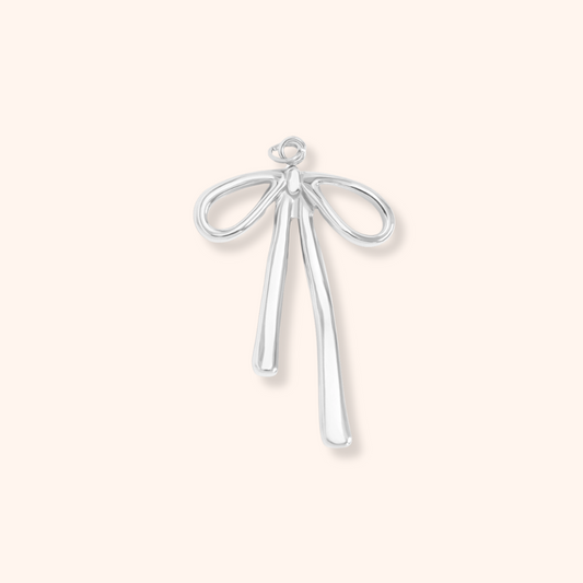 Silver bow-shaped pendant on a white background